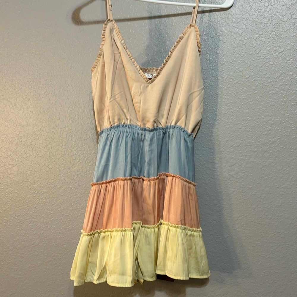 Pinkish orange, blue, and yellow romper form Storia. Size small.